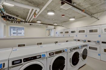 A row of washing machines in a laundromat.